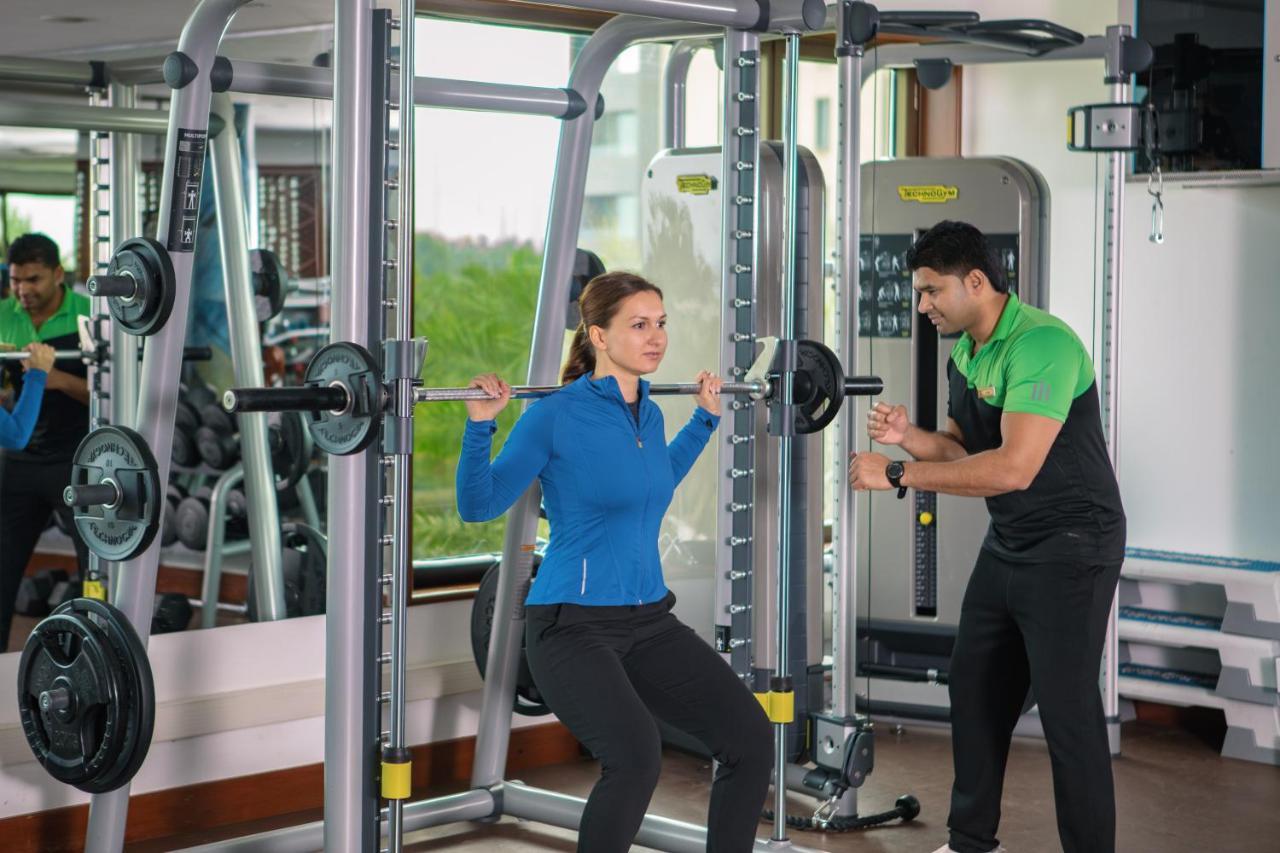 Jumeirah Messilah Beach Kuwait Kuwait City Exterior photo A personal trainer assisting a woman with a squat